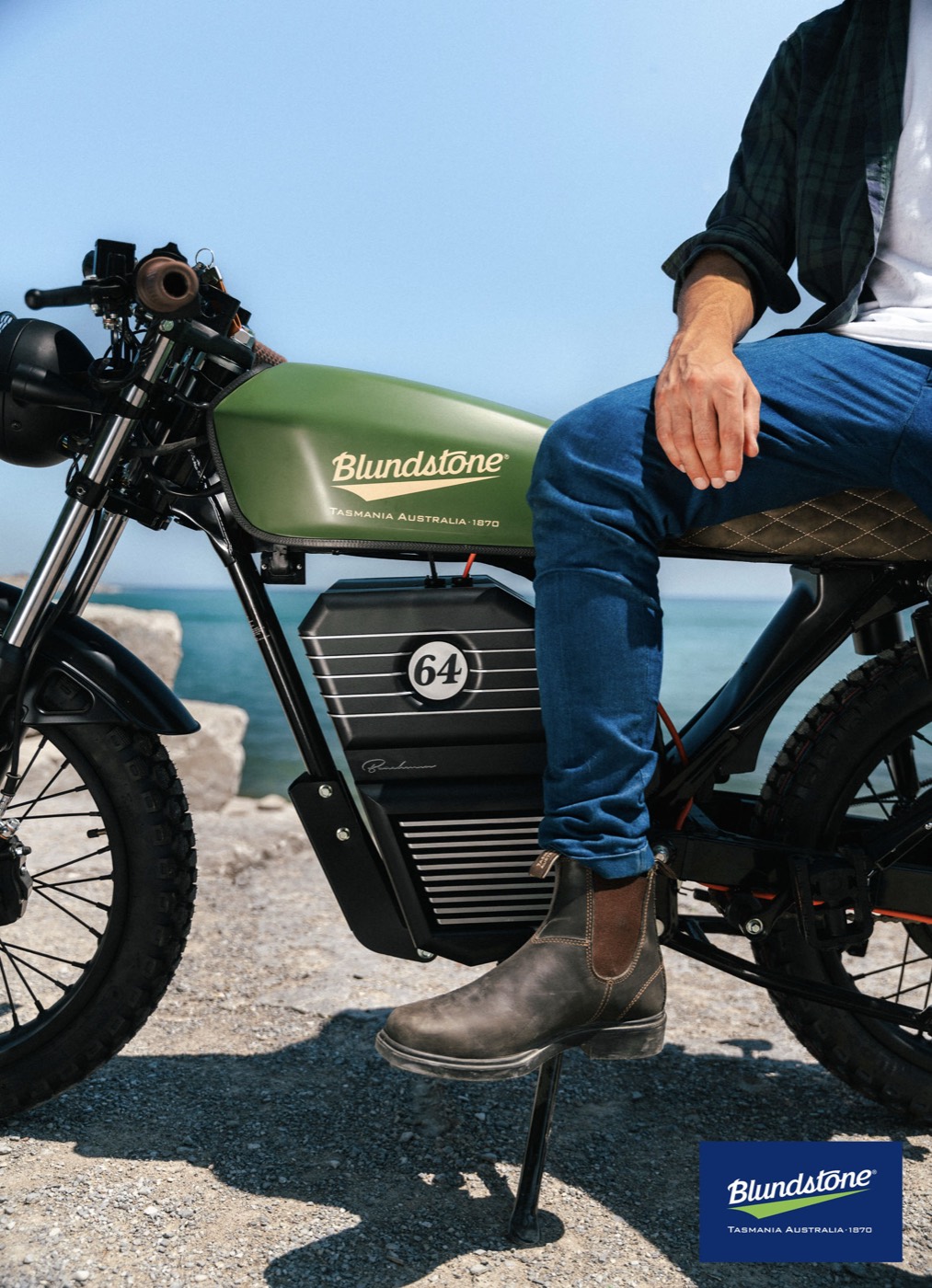 Rider in Blundstone boots on a green Beachman bike by the water