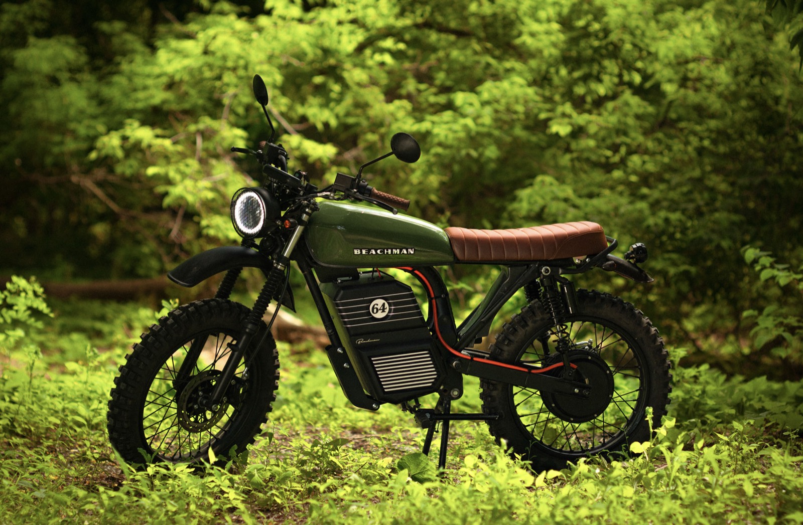 Green Beachman electric scrambler motorbike in dense forest