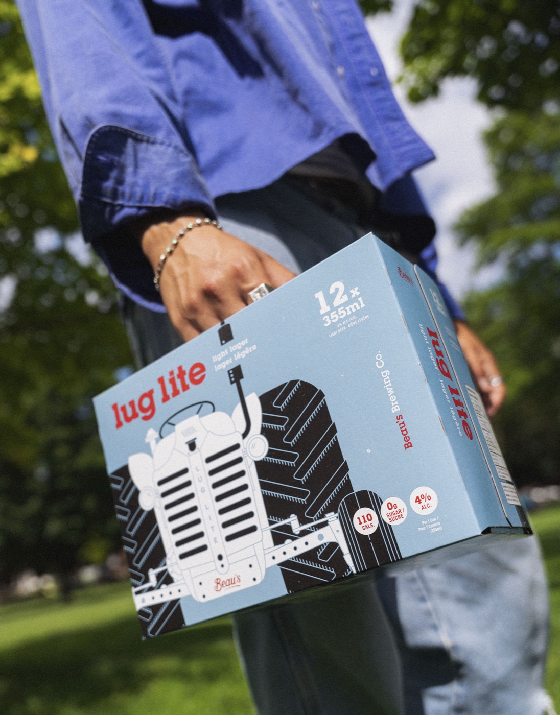 Hand carrying a Beau's Lug Lite case across a sunny park