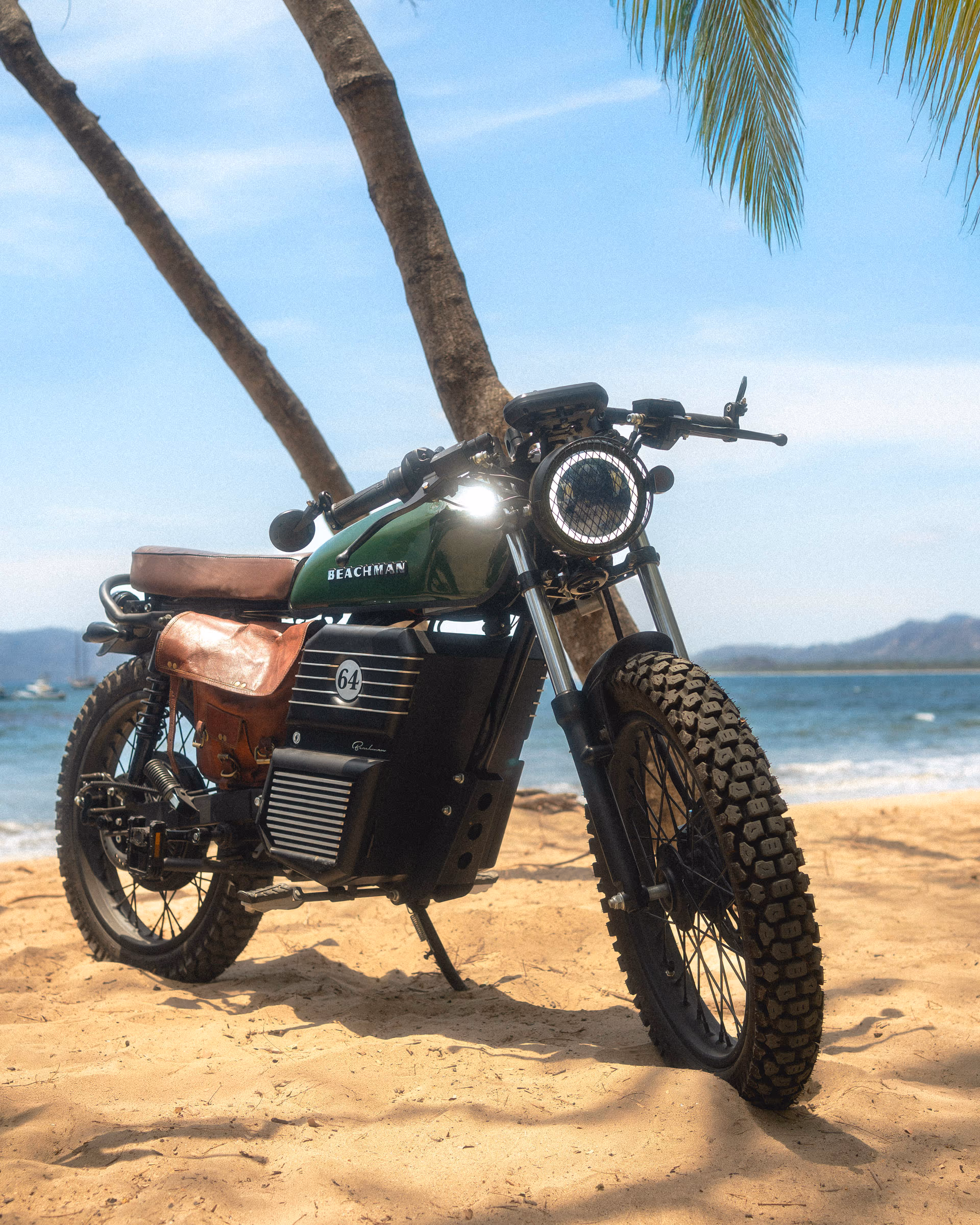 The Beachman on the sand beneath the palm canopy