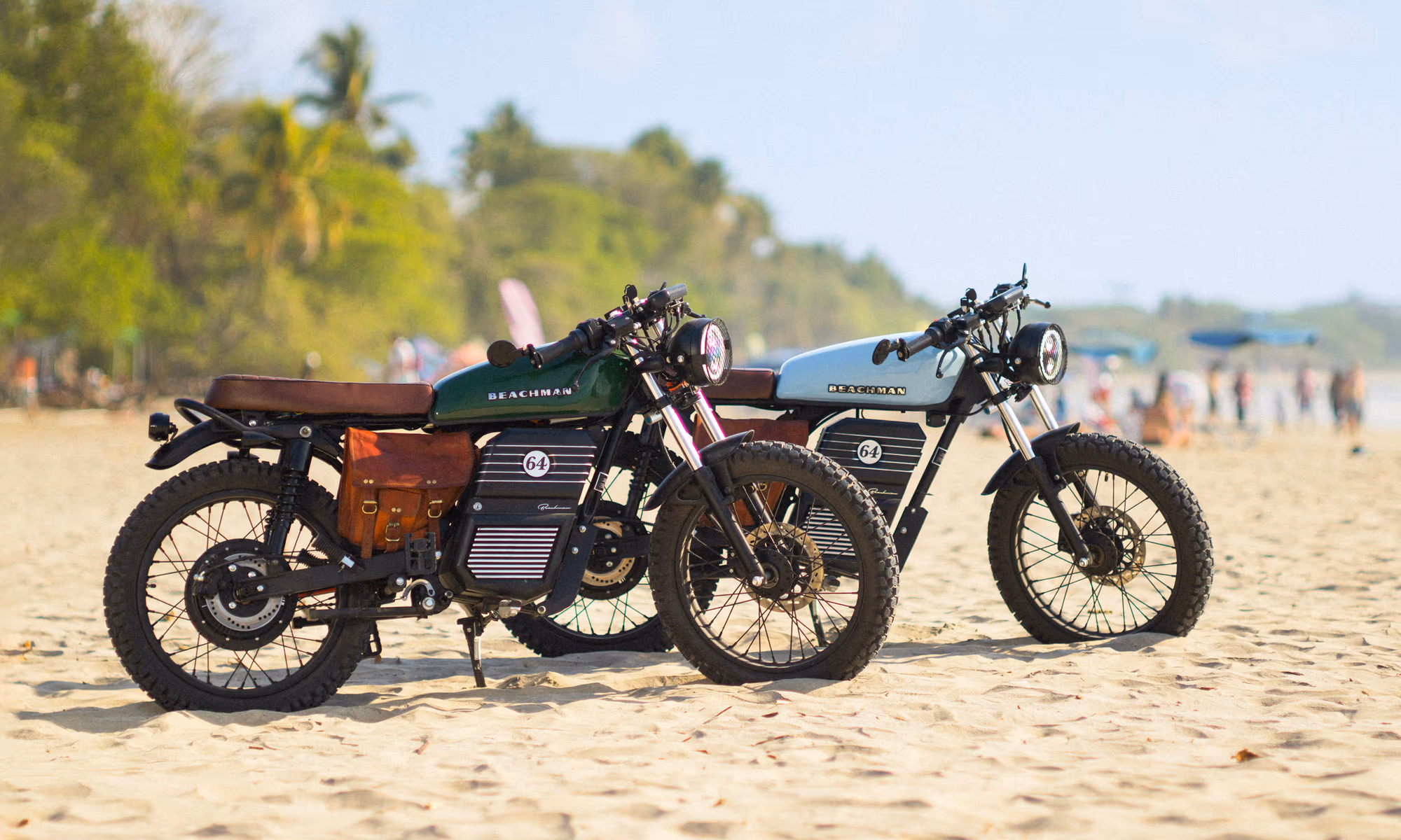 Two bikes parked on the busy beach