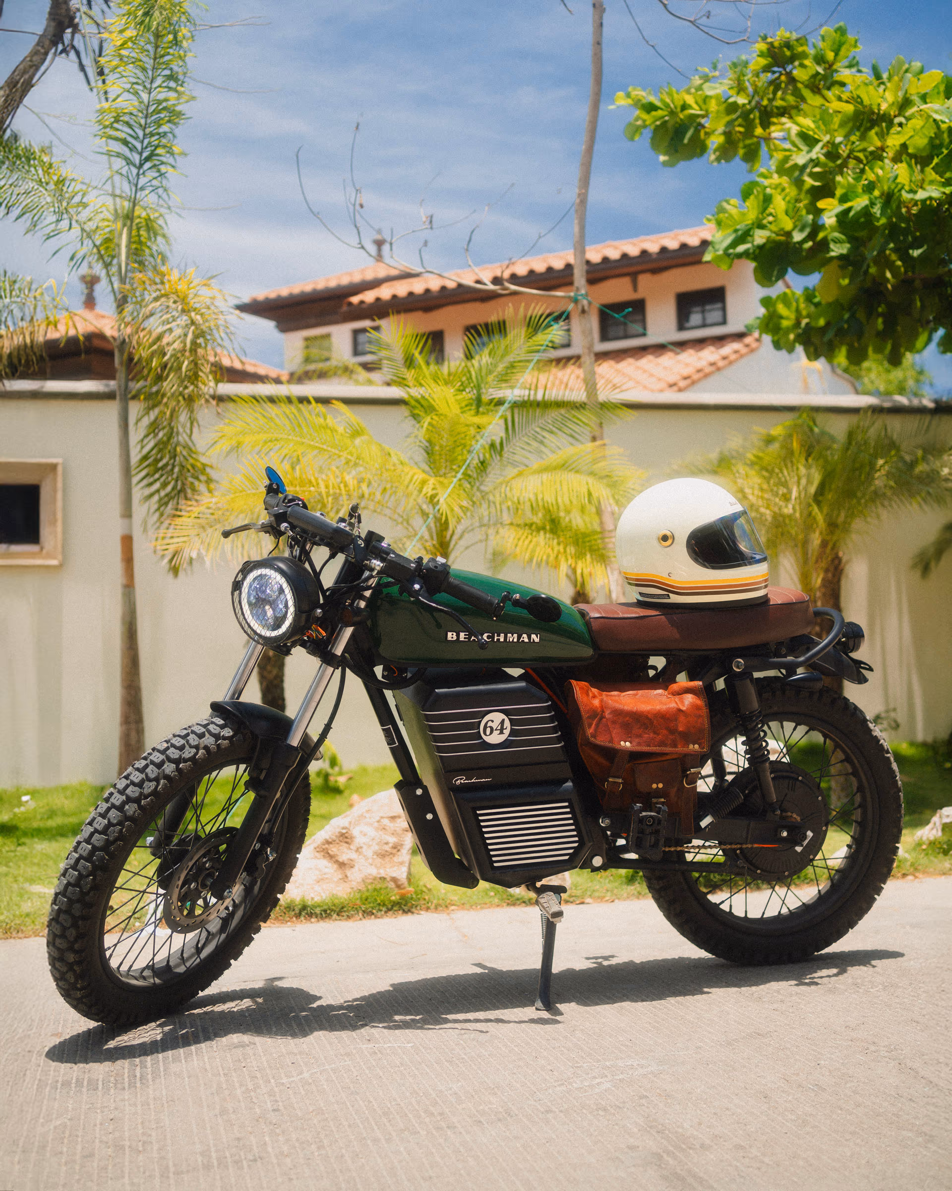 A Beachman '64 with a vintage helmet parked under the palms in Costa Rica