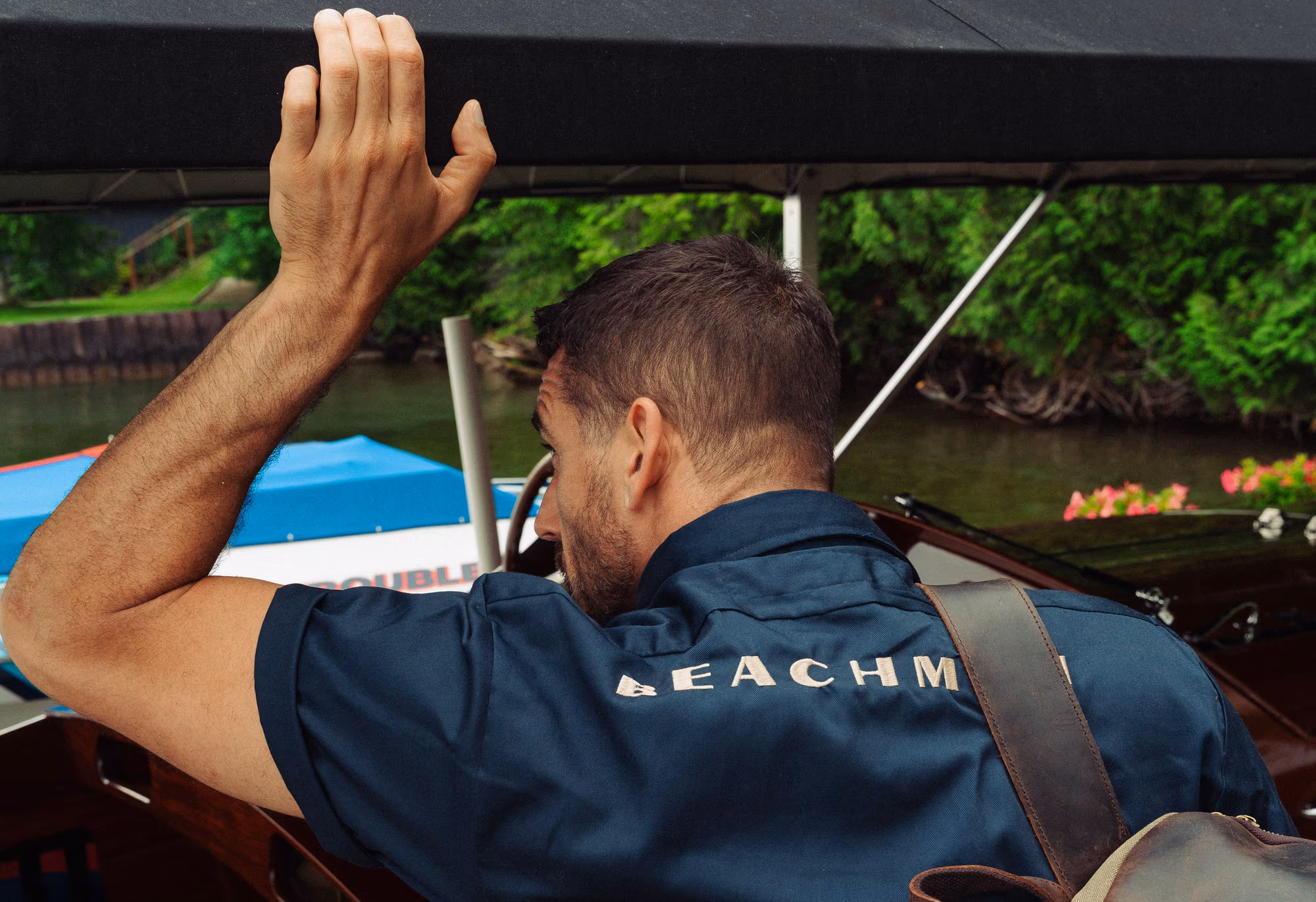 Shielding the sun at the boat in the navy Beachman work shirt