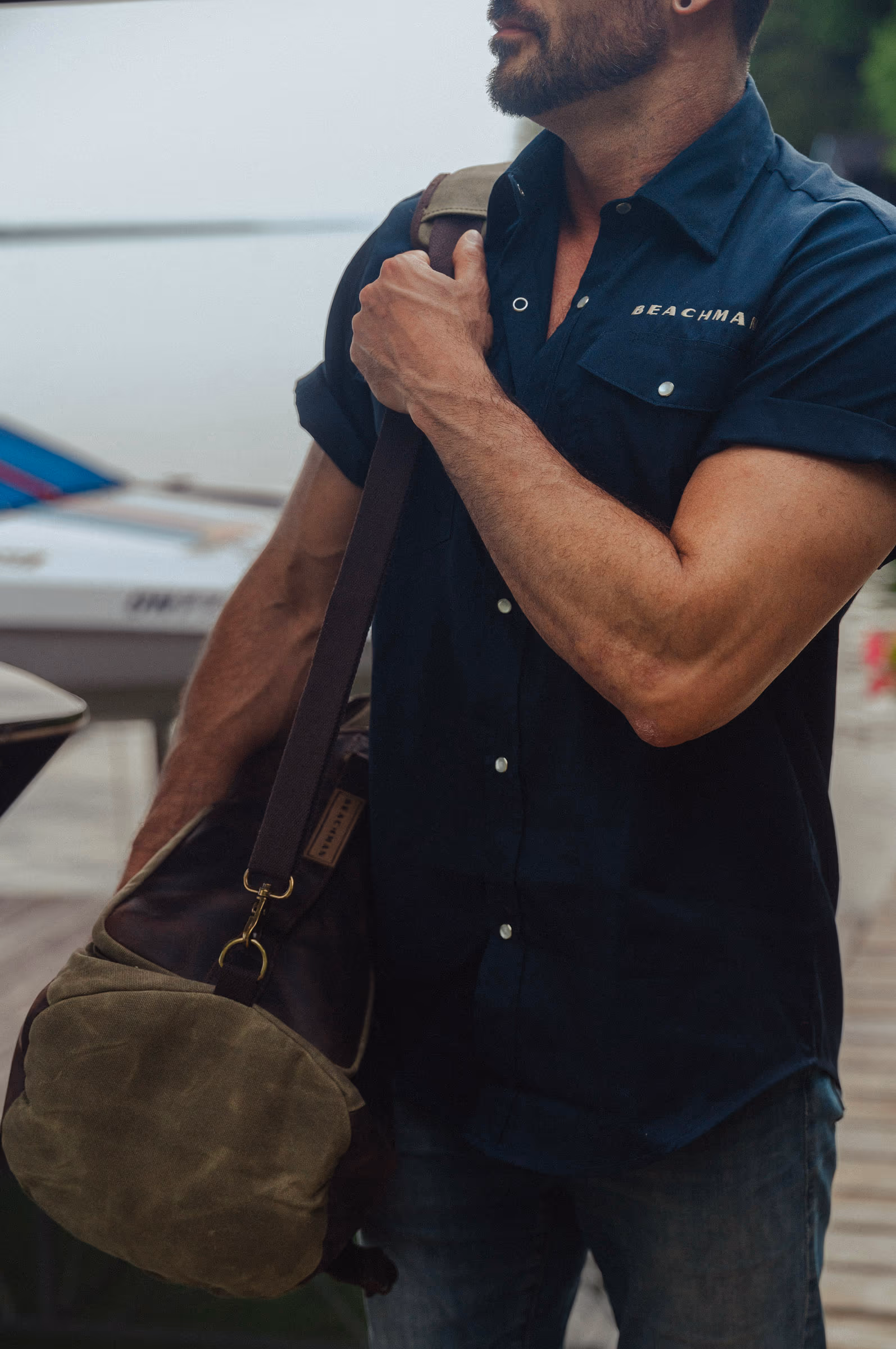 Shouldering the waxed-canvas duffel on the dock
