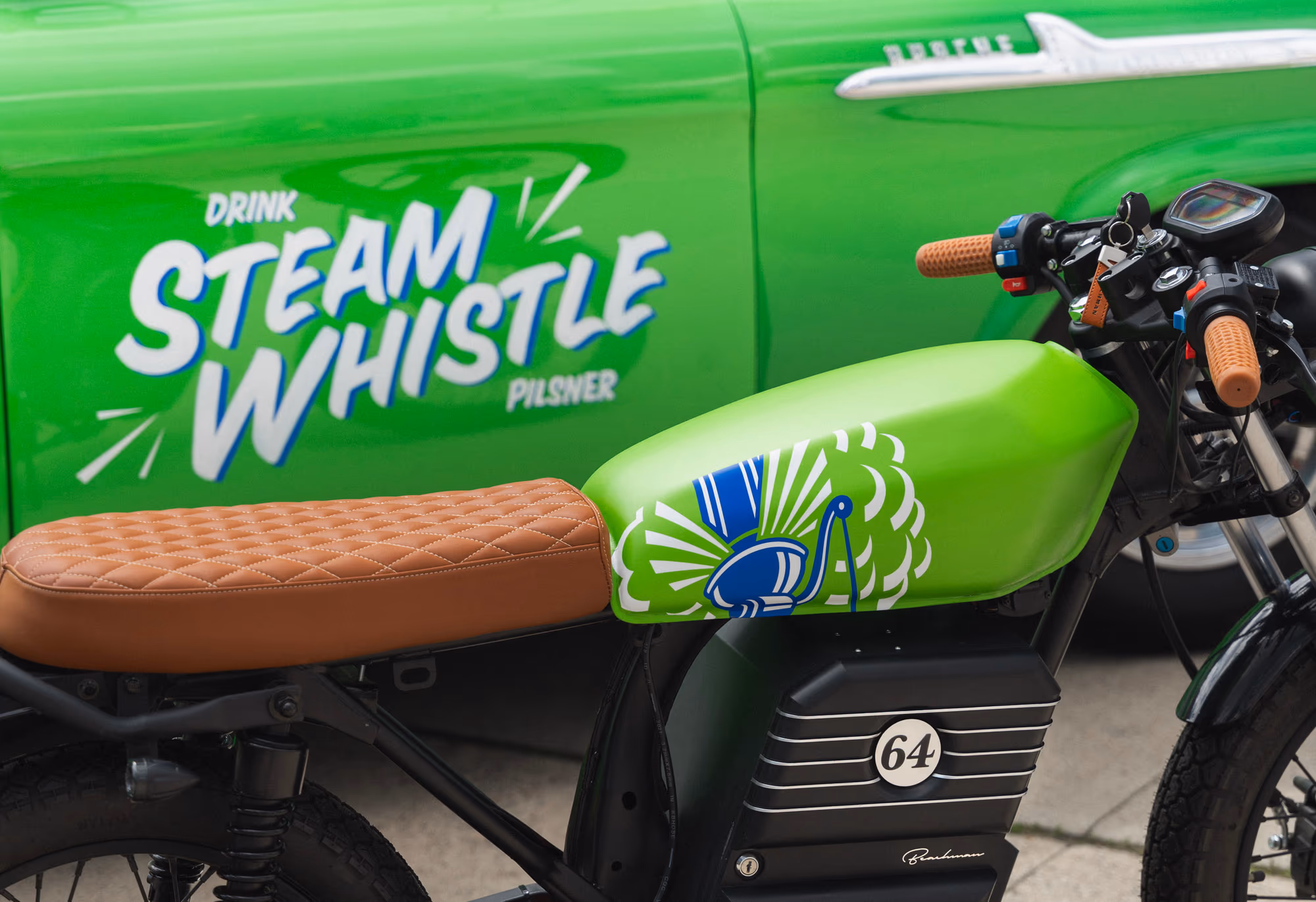 The custom bike beside a matching vintage green pickup