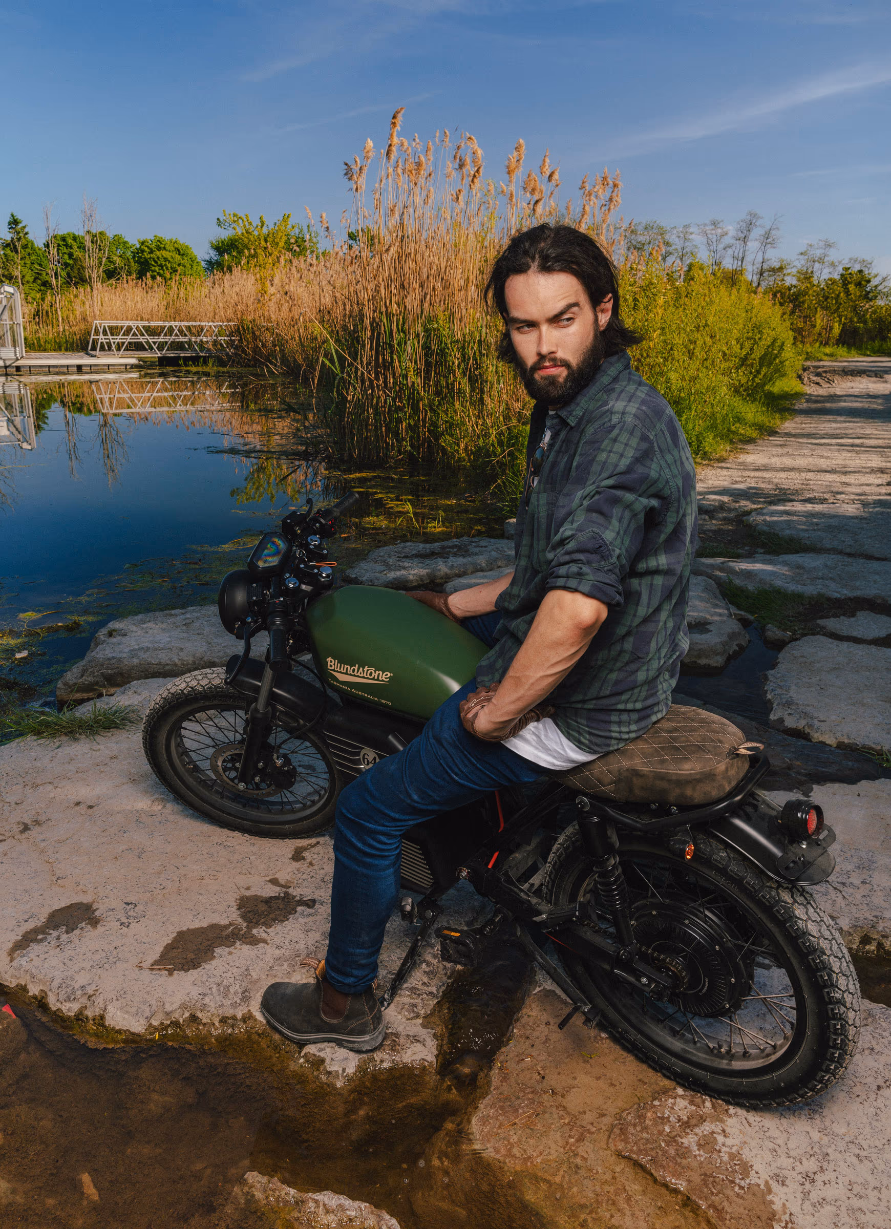 Parked by the marsh pond, boots on the pegs
