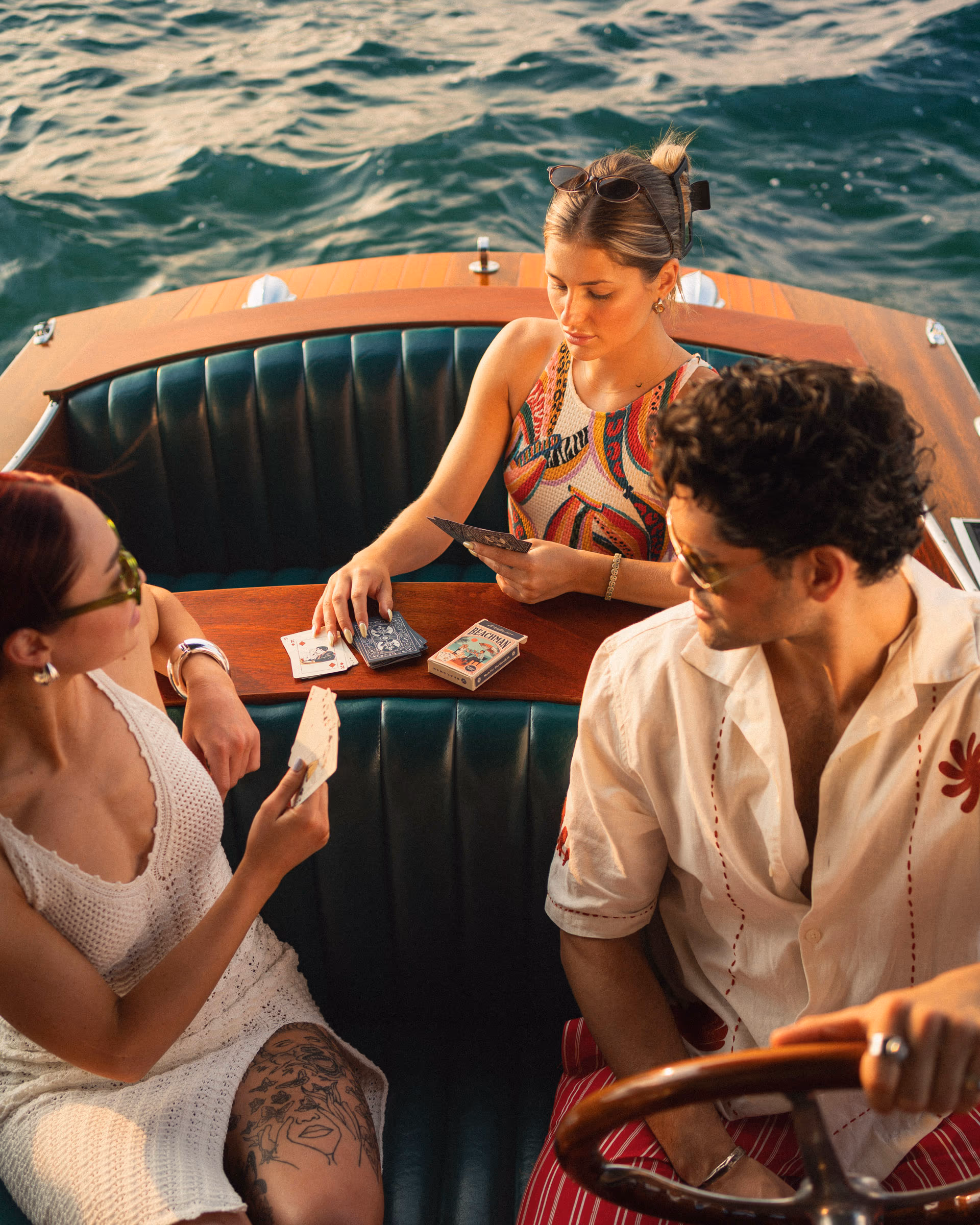 A card game in the cockpit of a vintage runabout
