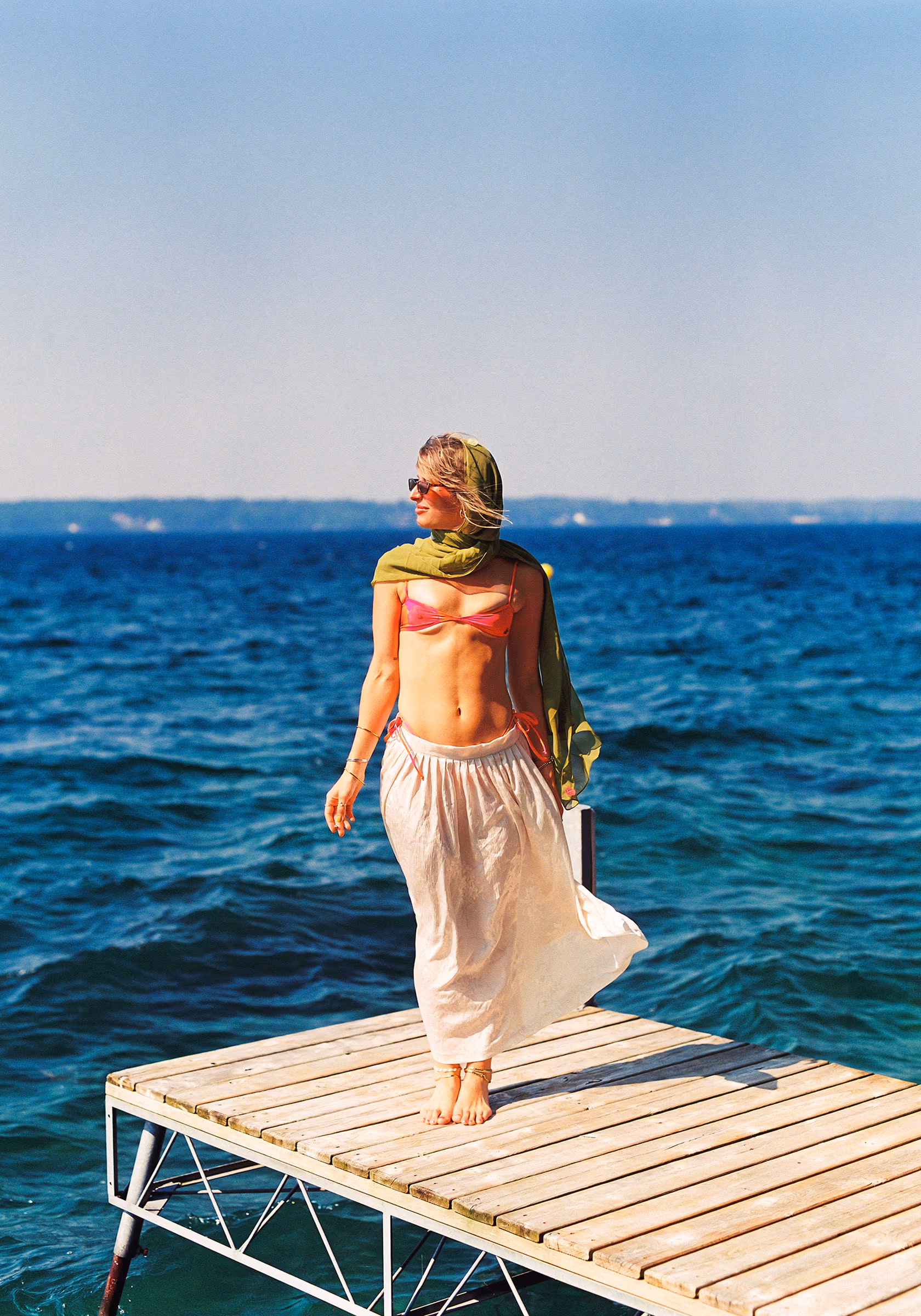 Walking the dock in a flowing skirt, lake wide open behind