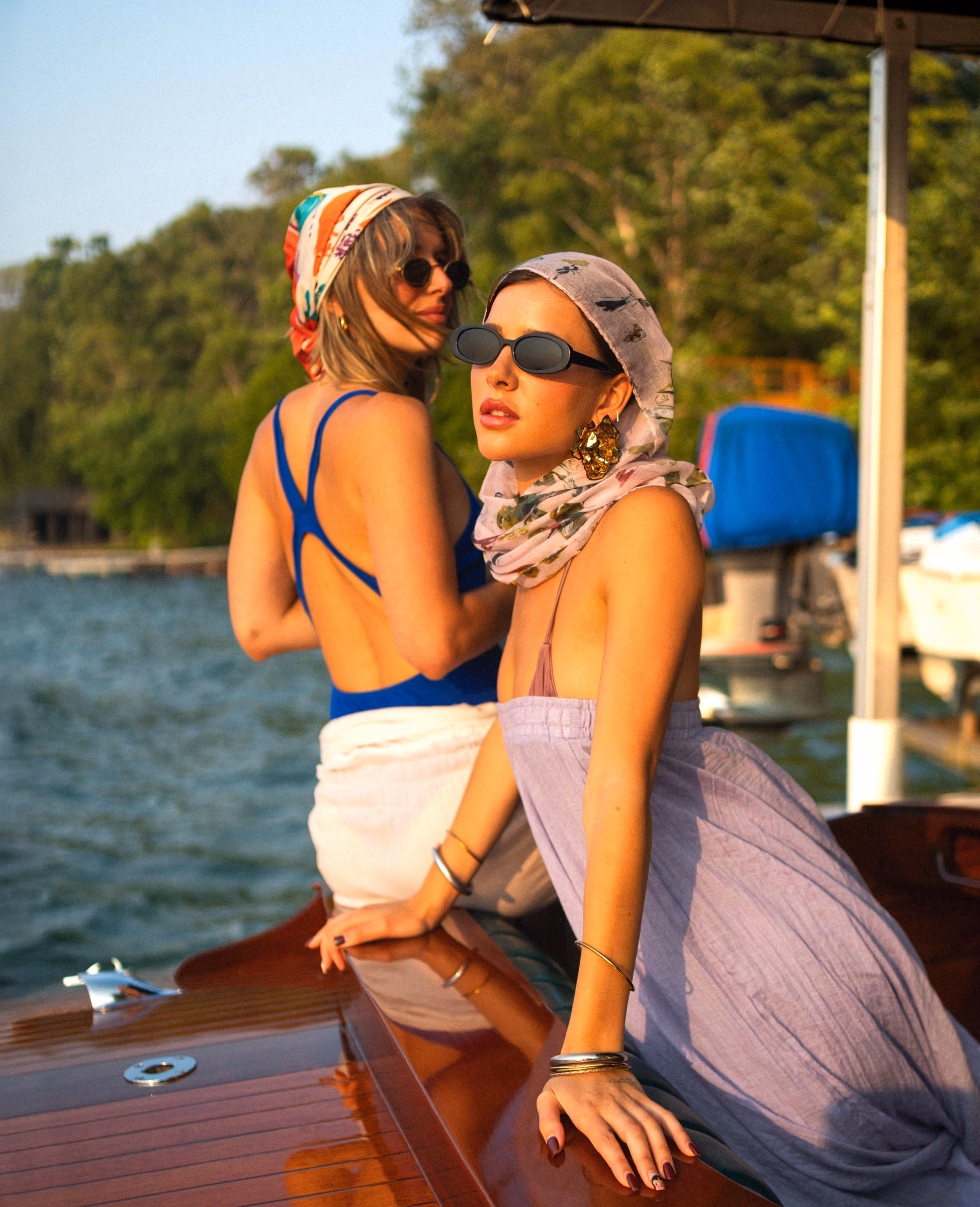 Two friends in headscarves aboard the wooden boat