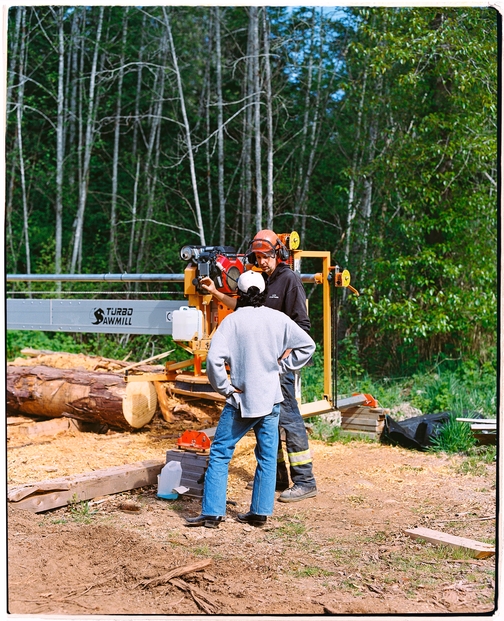 Working the sawmill together in the pine woods