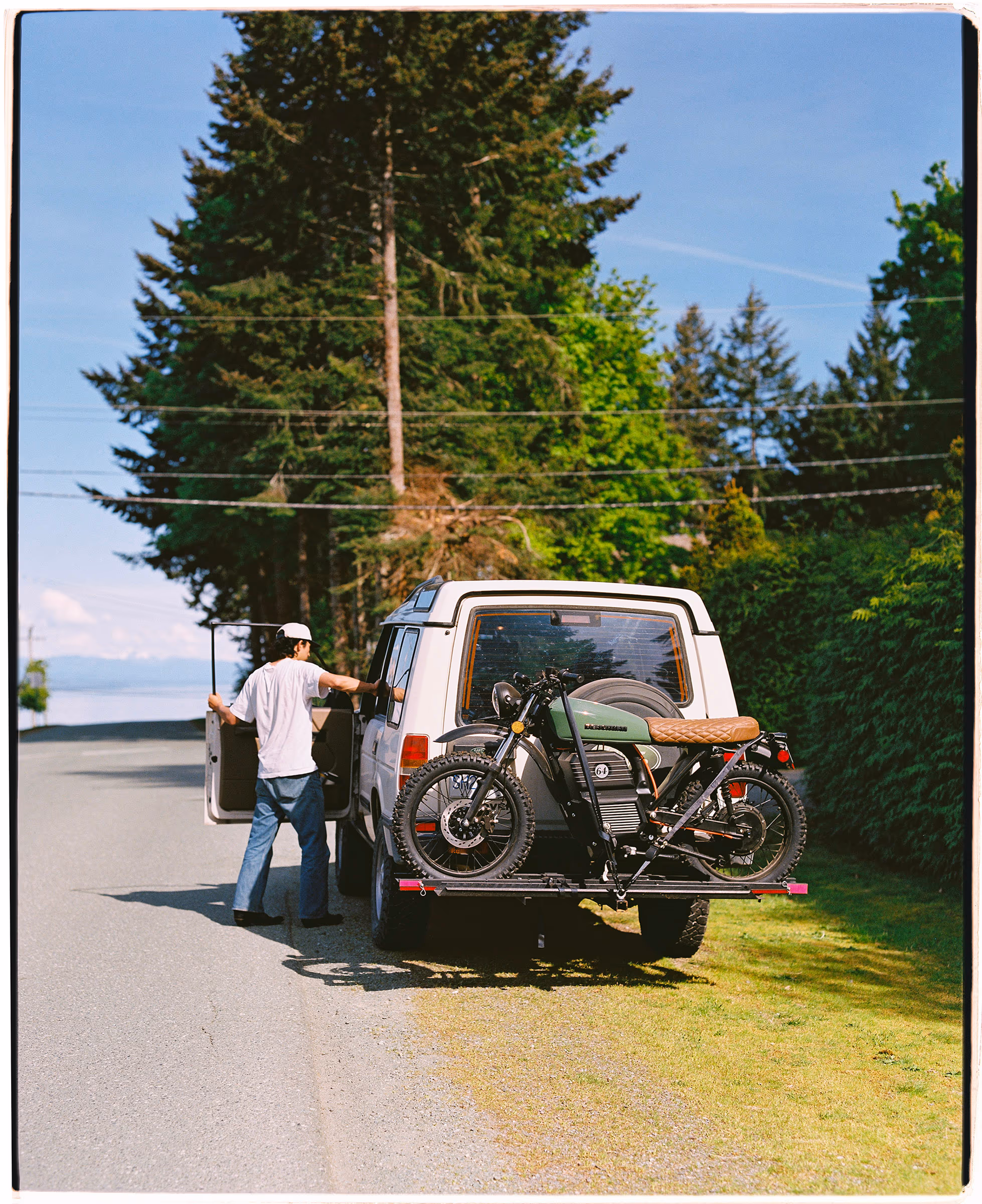Strapping the motorbike onto the truck rack on a pine road