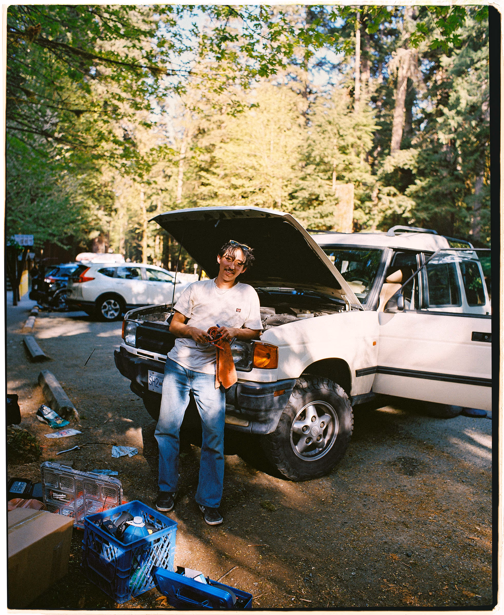 Under the open hood of the 4x4, deep in the woods