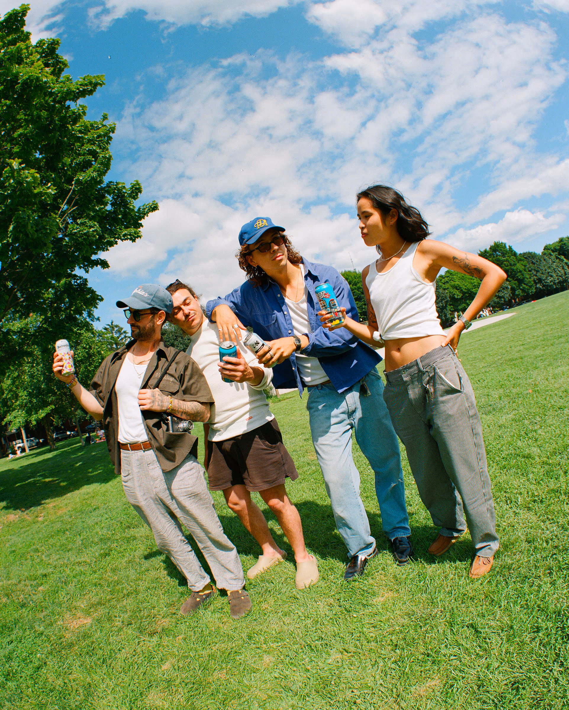 Friends goofing around on a sunny park lawn with Lug Lite in hand
