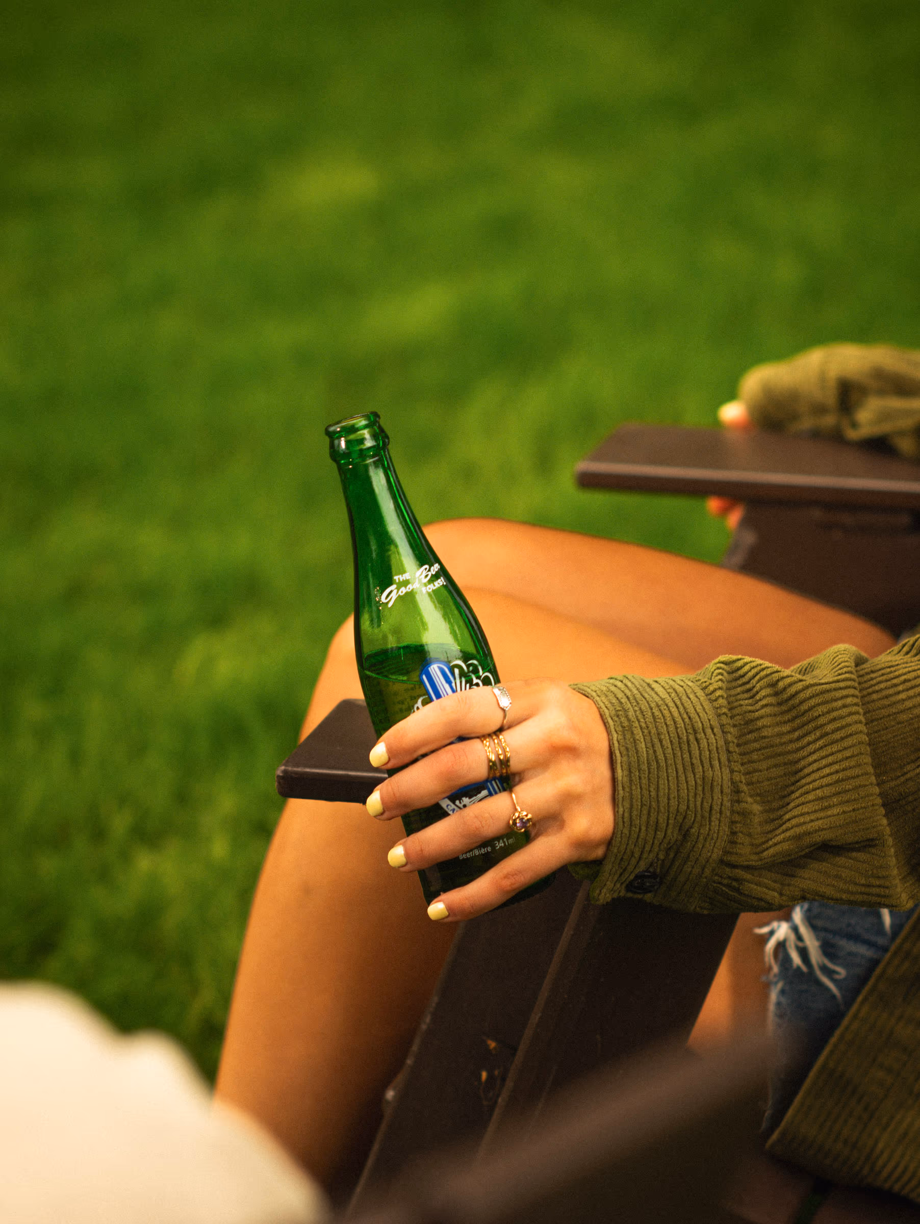 A bottle dangling easy off the chair arm