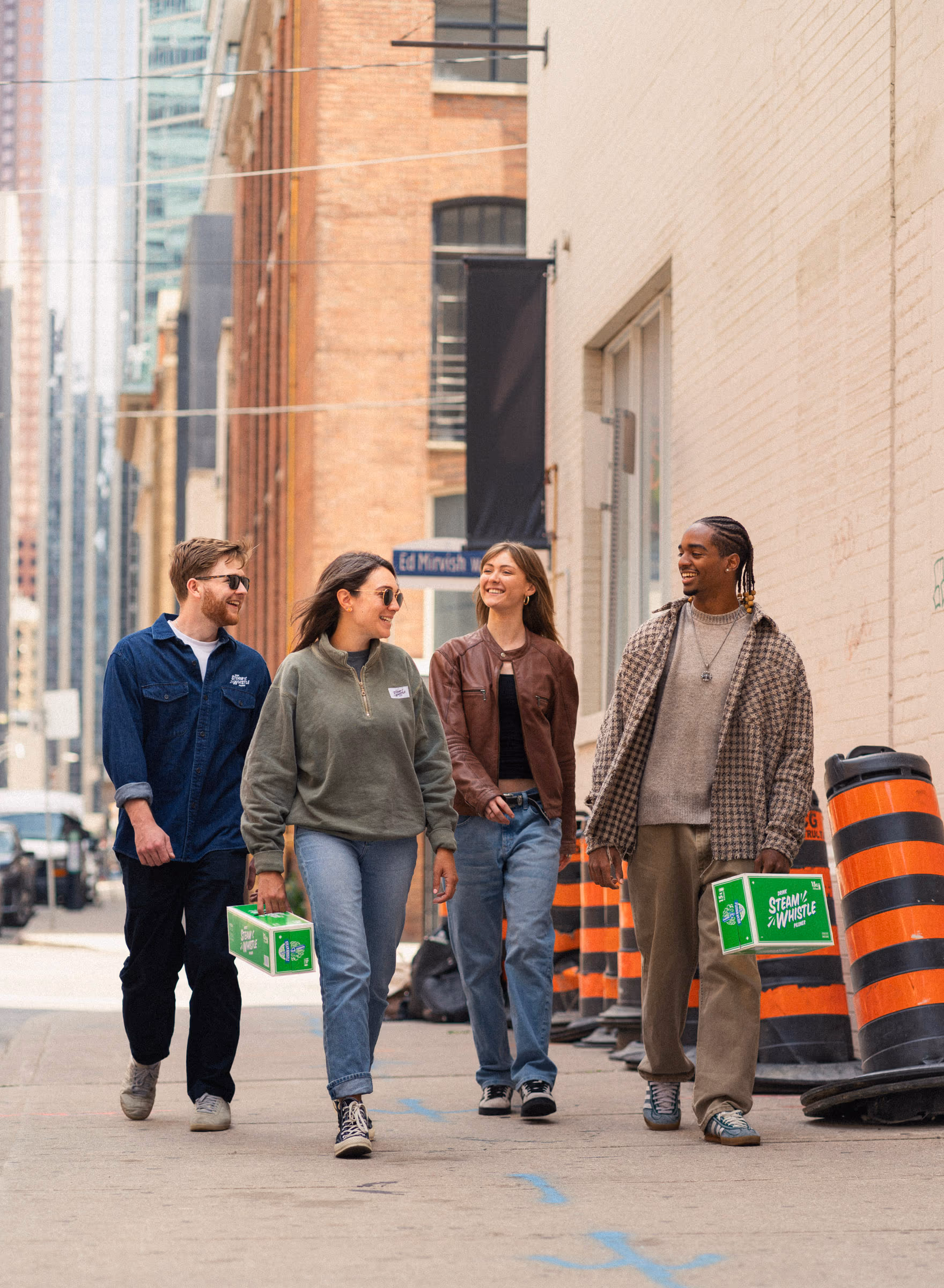 Friends walking the city street, boxes in hand