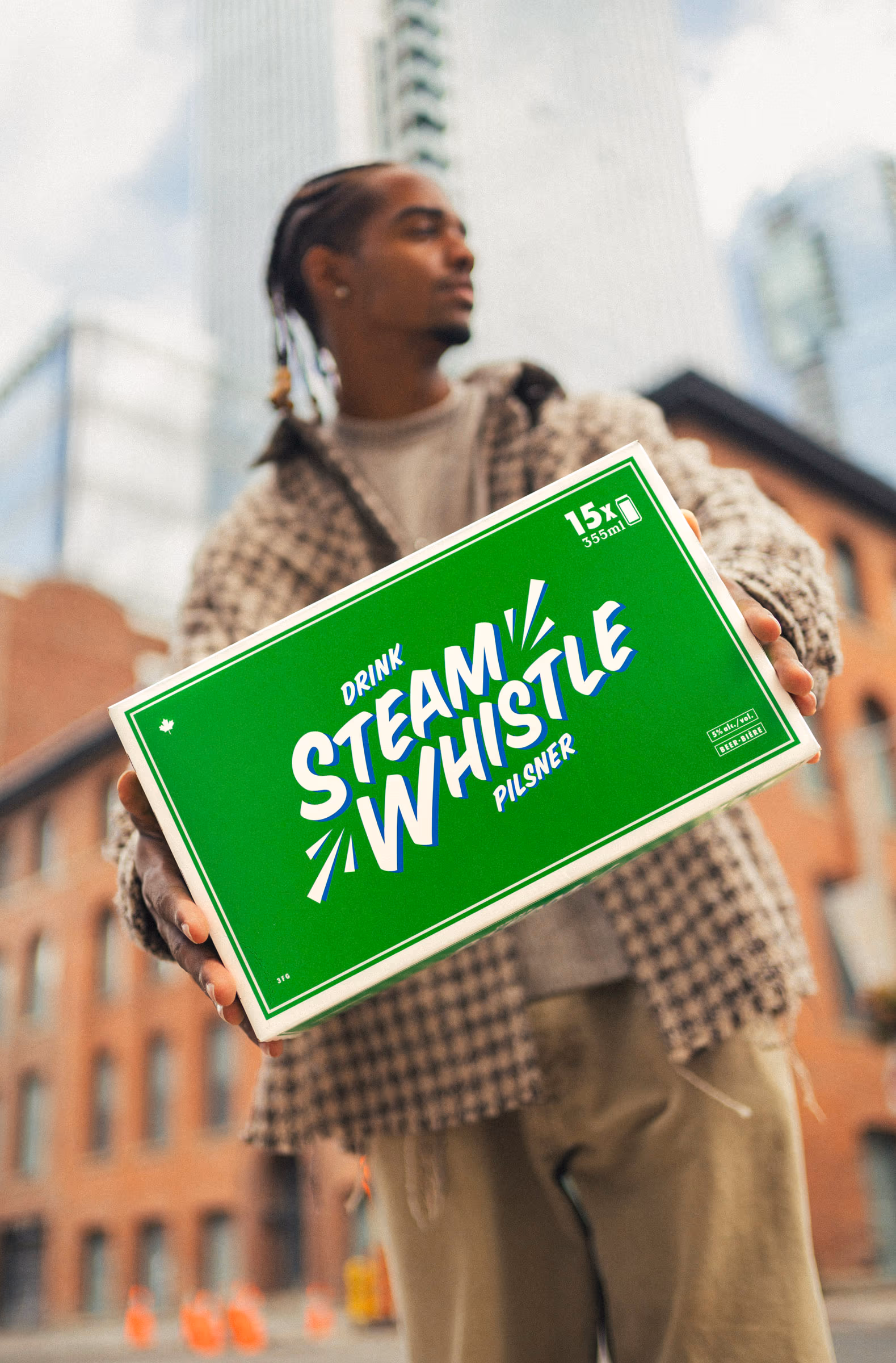 Carrying a 15-pack through downtown in a plaid jacket