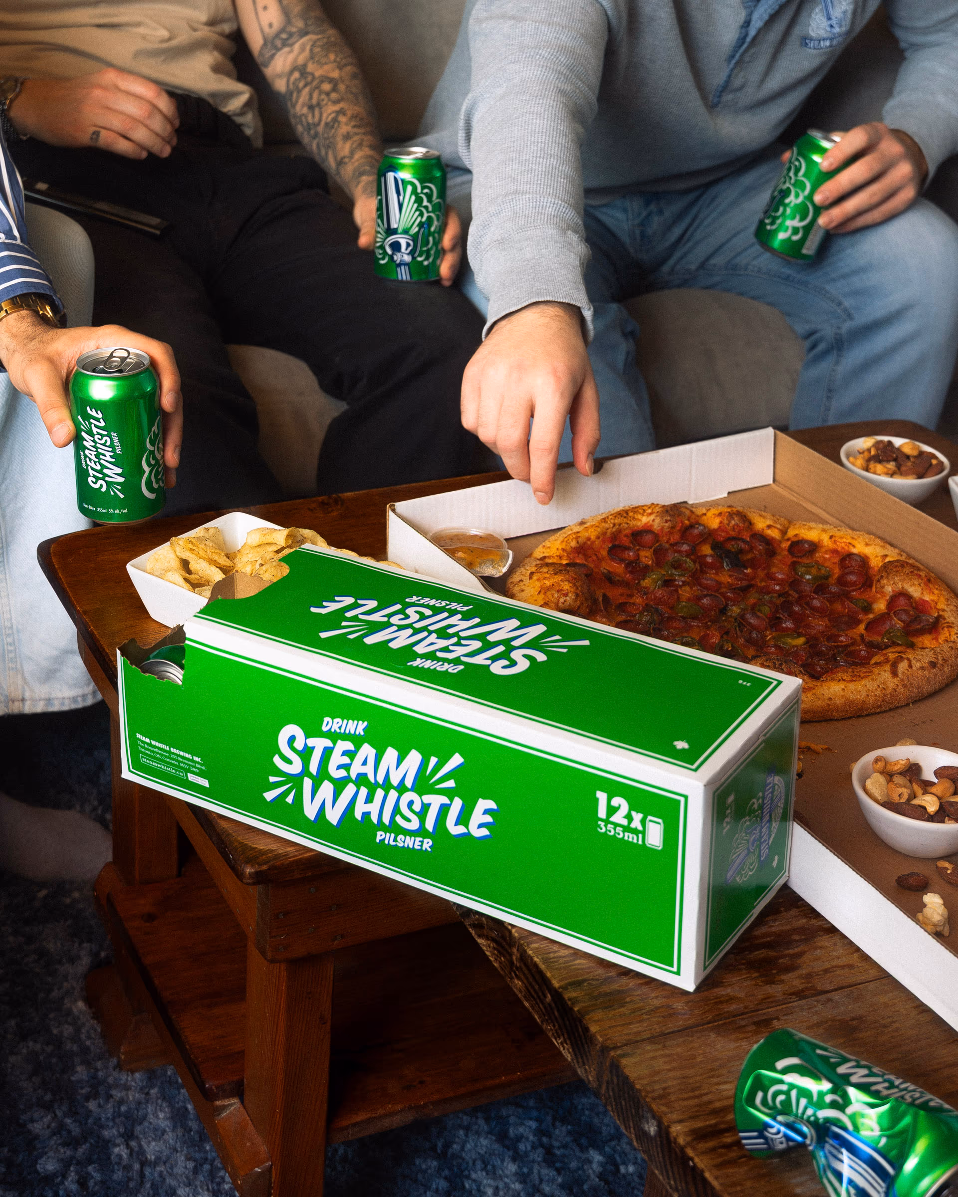 The spread from above — pizza, chips and a cold can