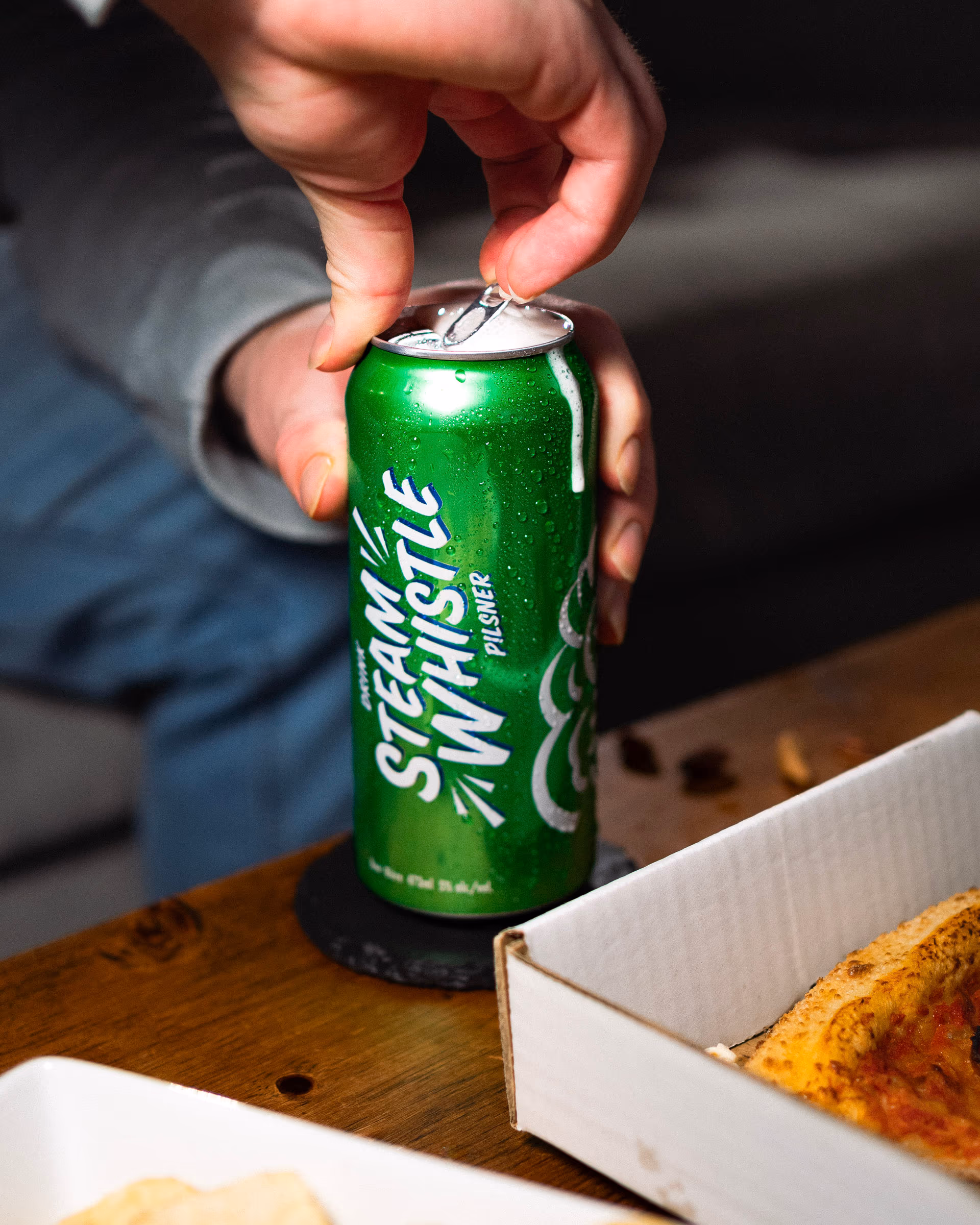 Cans cracking open over the snacks