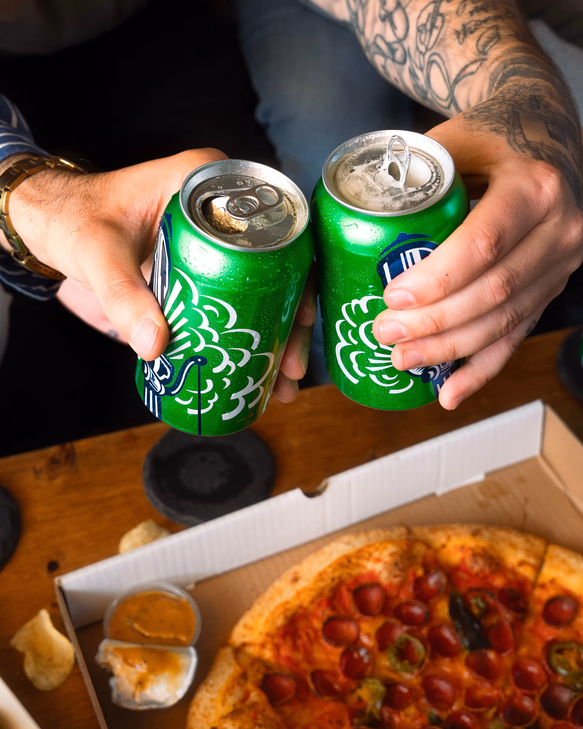 A can standing tall on the pizza box