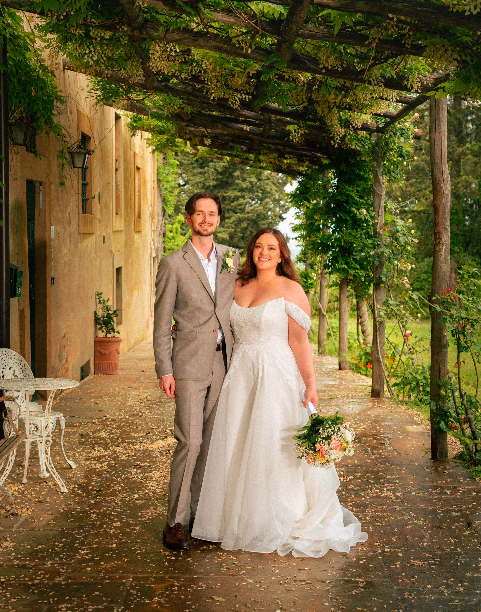 Walking hand in hand under the vine-covered pergola