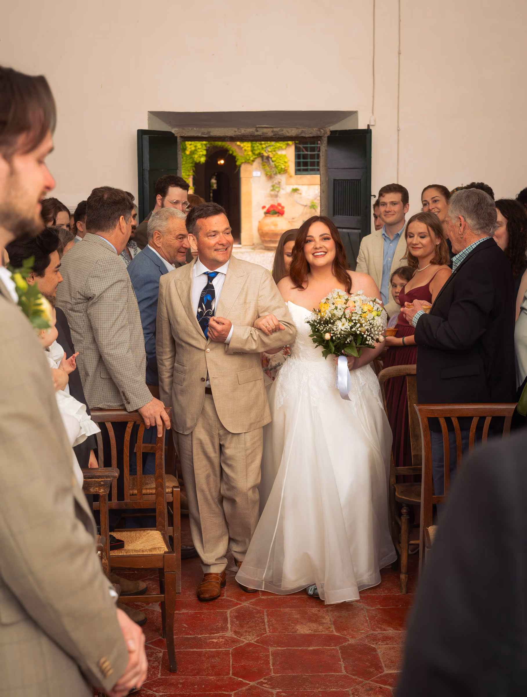 The bride walking down the aisle on her father’s arm