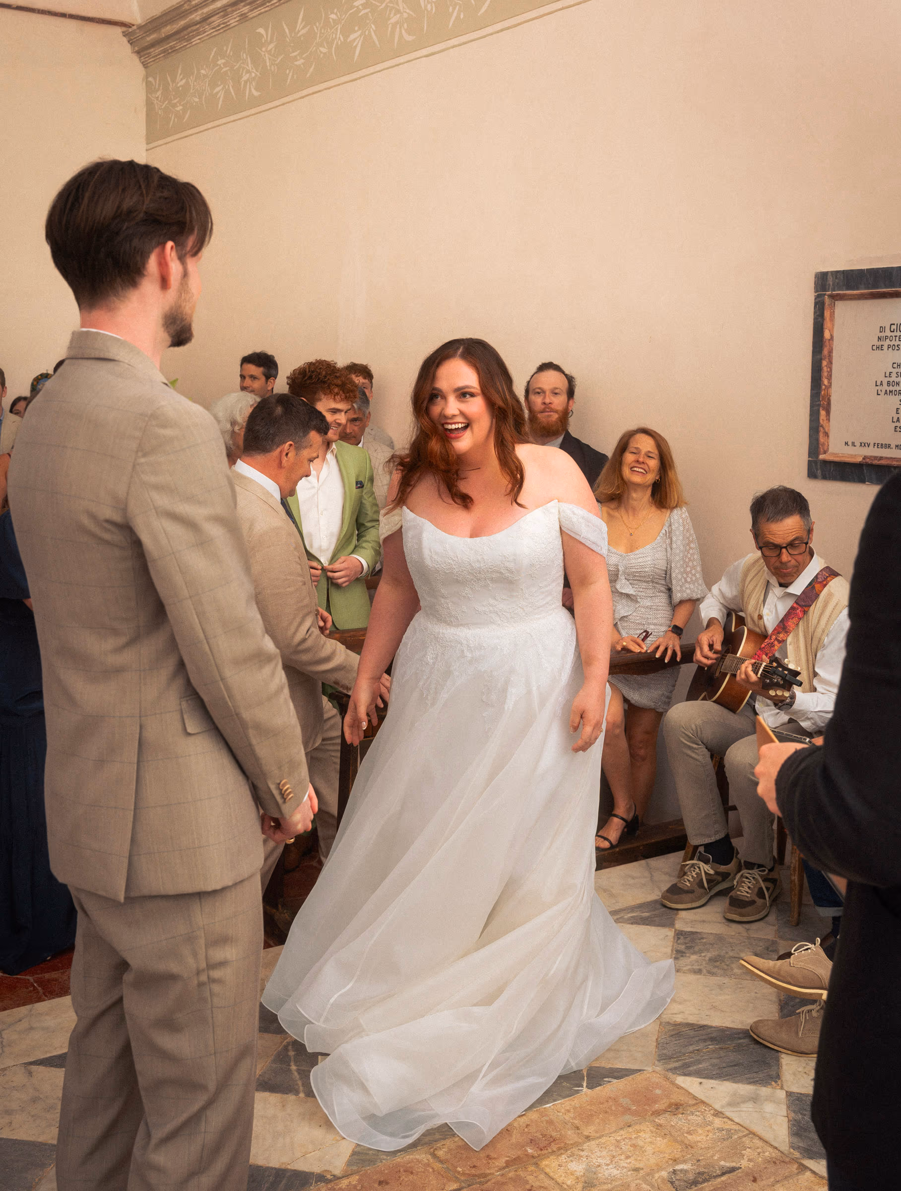 Bride and groom before their guests, dress in a swirl