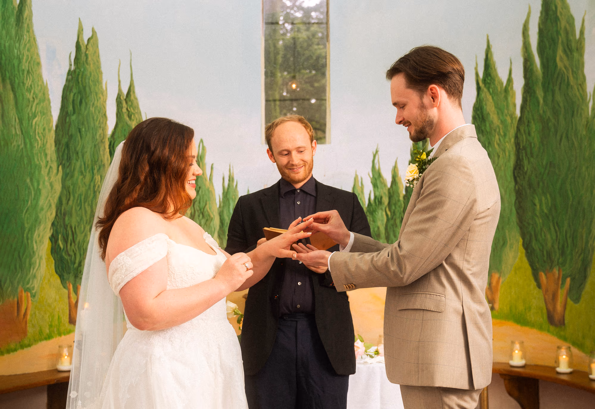 The ring exchange in front of the painted cypress mural