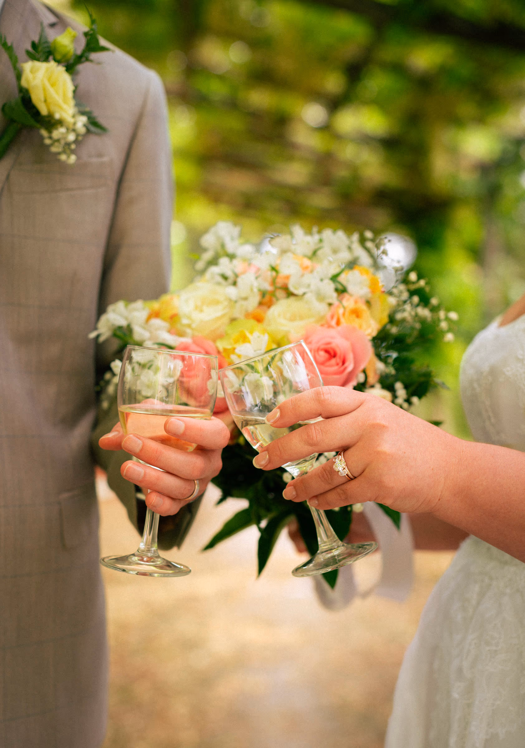 A toast — two glasses over the bouquet