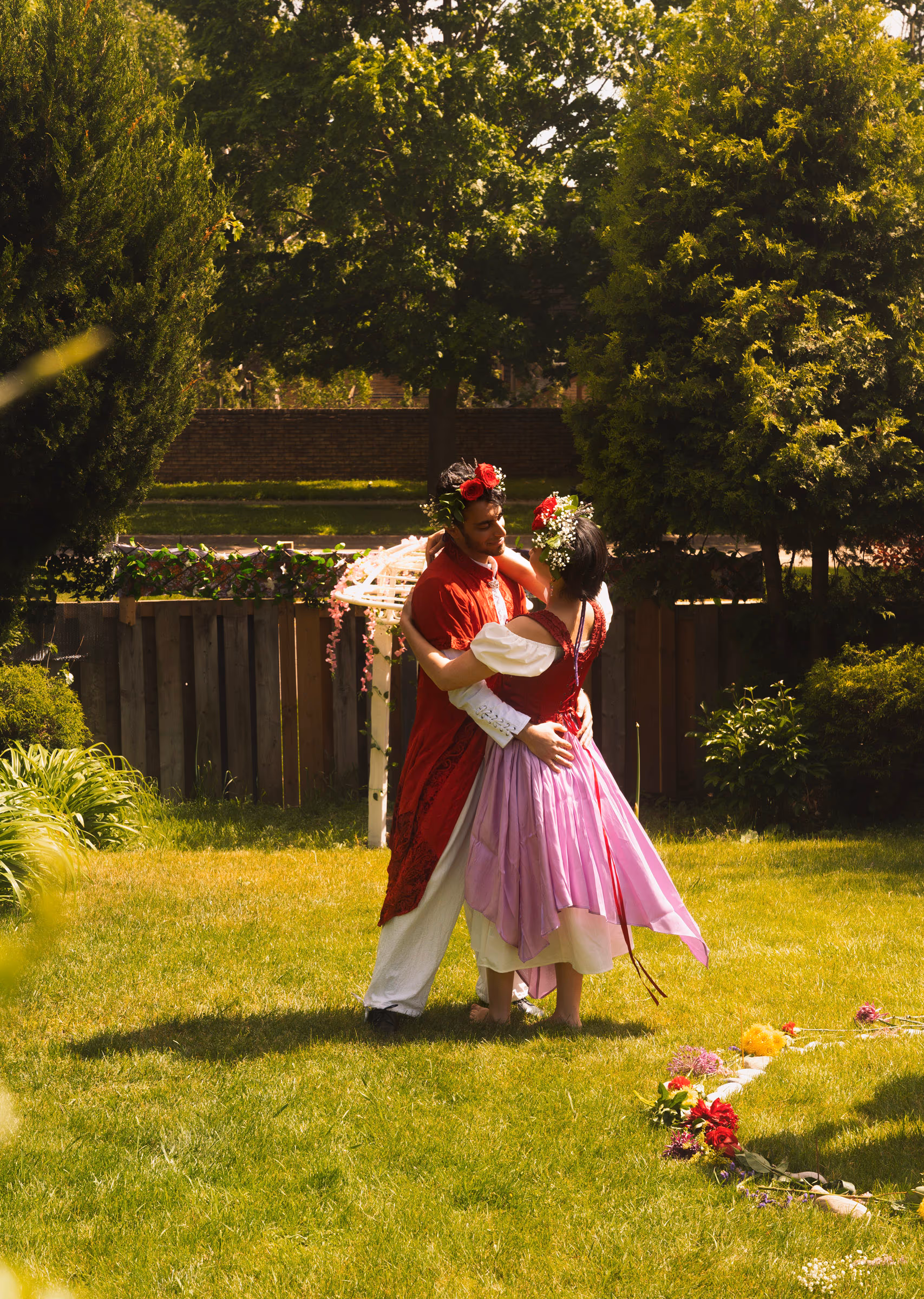 Dancing across the lawn, flowers scattered in the grass