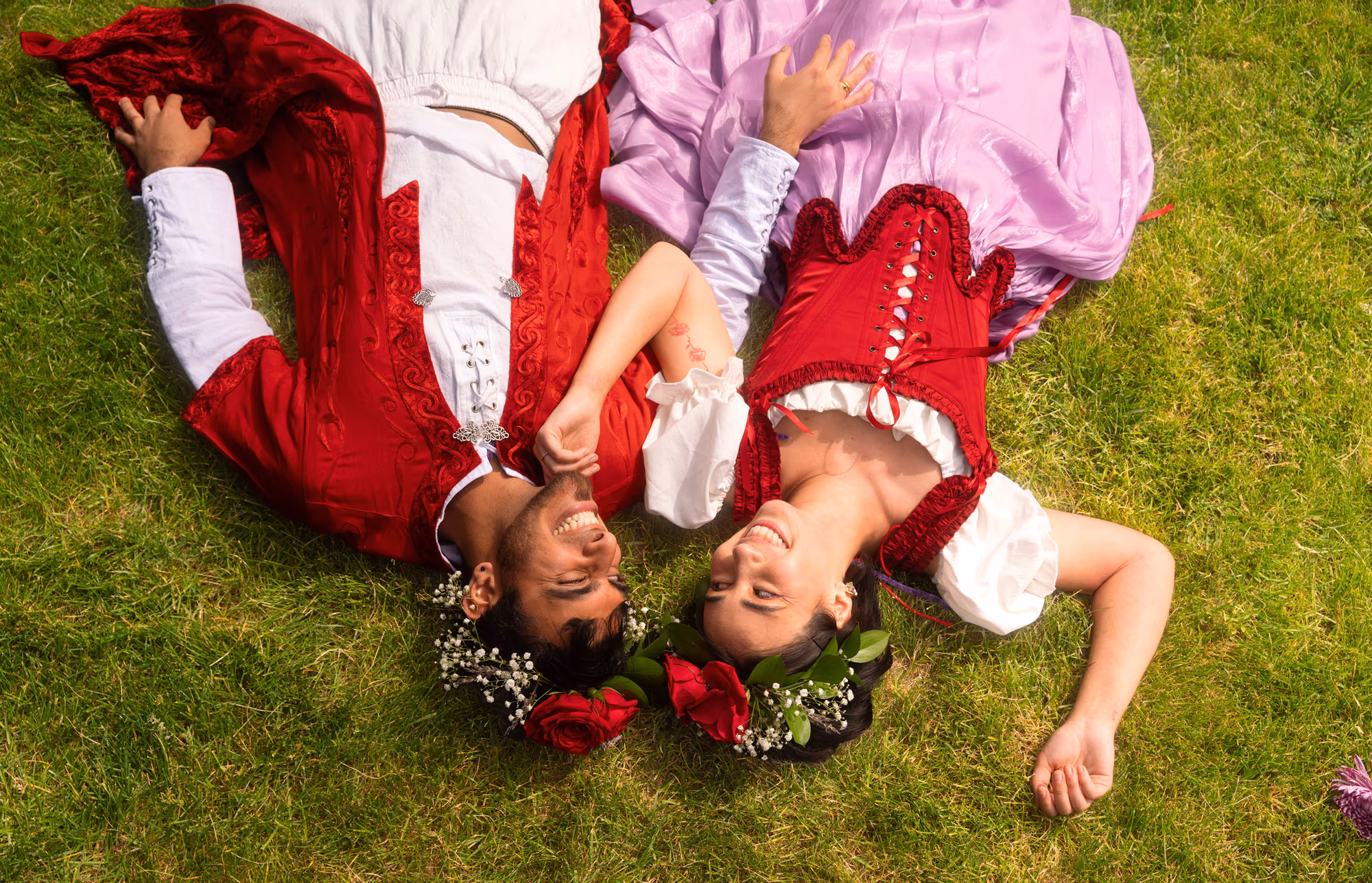 Lying head to head in the grass, laughing