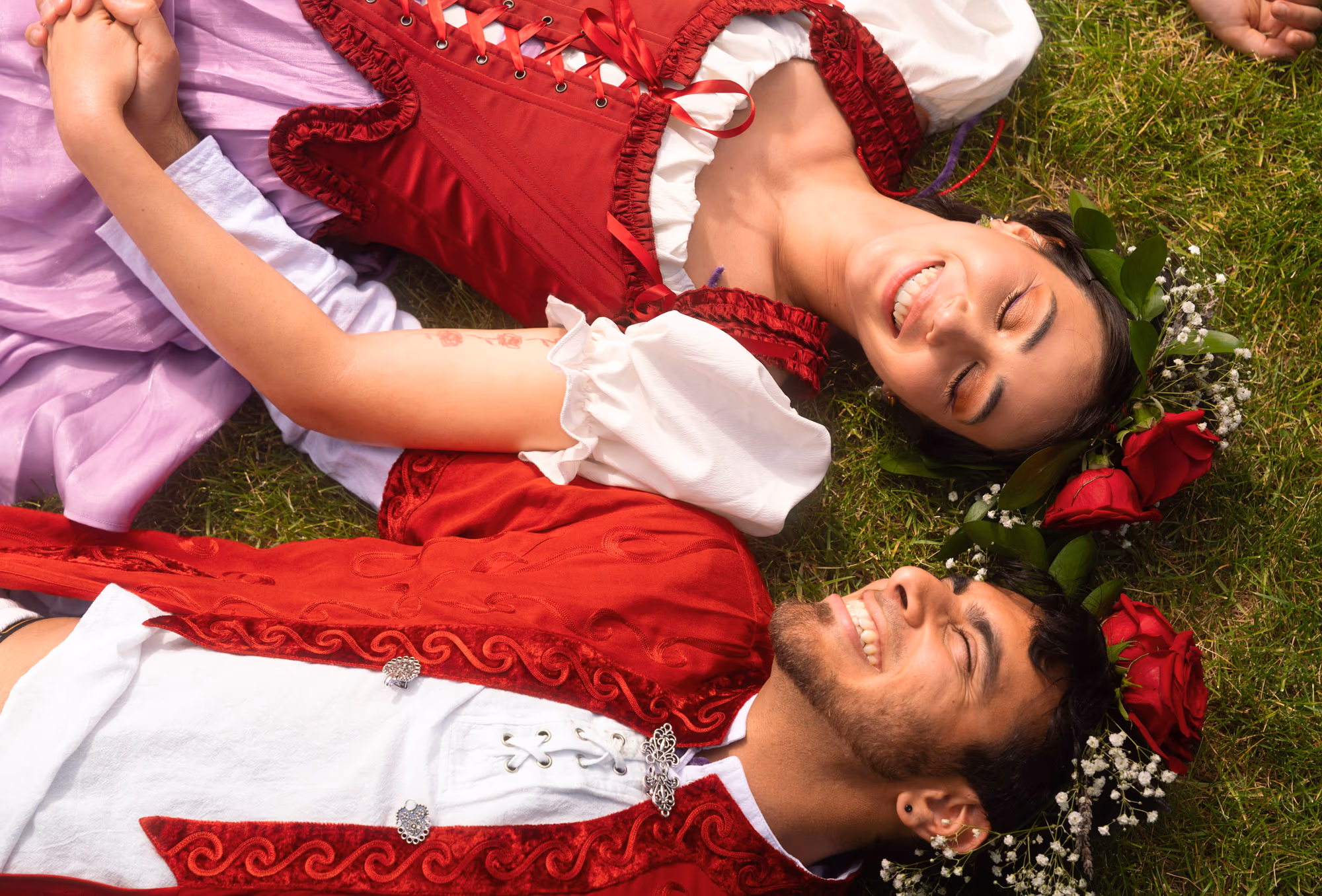 The two of them flat on the lawn, mid-laugh
