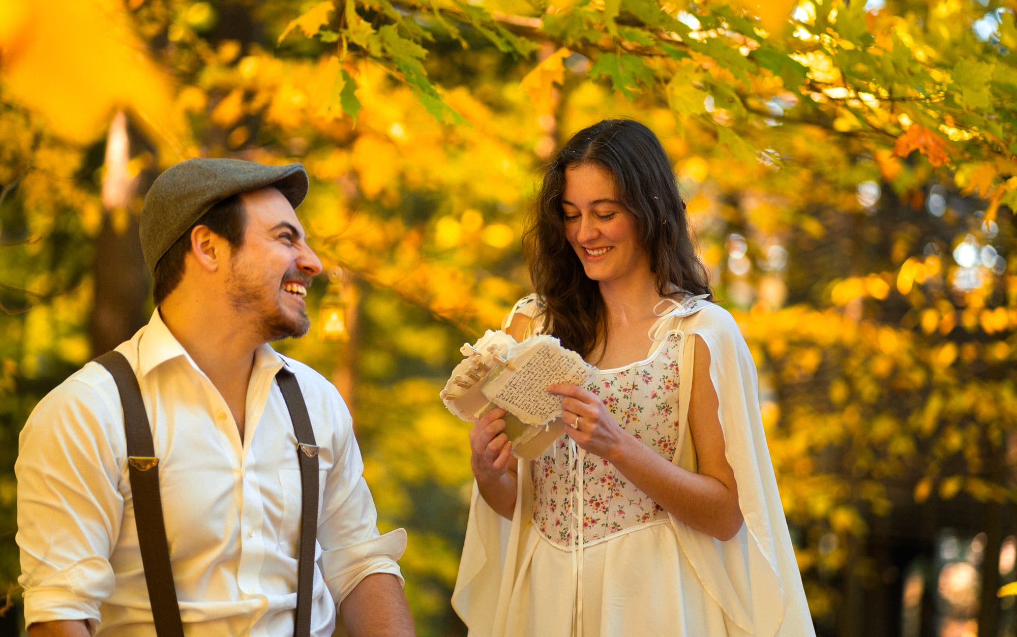 The couple sharing a laugh outdoors in autumn